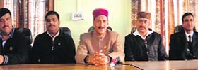 Former minister Ravinder Singh Ravi (centre) addresses a press conference in Palampur on Thursday