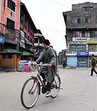 A cyclist pedals his way on a deserted road