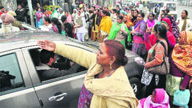 Aanganwari workers stop a car during their protest at Bharat Nagar Chowk in Ludhiana on Thursday.