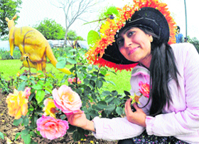 A girl poses with roses at the Rose Garden in Chandigarh on Friday.