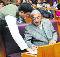 Industry Minister Randeep Singh Surjewala discusses a point with Chief Minister Bhupinder Singh Hooda on the opening day of the budget session in Chandigarh on Friday. 