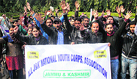 Members of the J&K National Youth Corps Association stage a protest in support of their demands in Jammu on Friday
