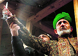 A cleric displays the holy relic believed to be of the Sufi saint in Srinagar on Friday