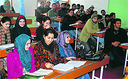 Students attend a class on a cold day in Srinagar on Friday