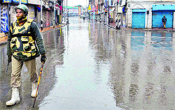 A CRPF soldier patrols streets during curfew in Srinagar on Friday