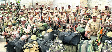 Paramilitary personnel wait for the announcement about their election duty in Moga Friday. The Moga constituency will go to polls on Saturday.