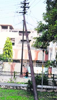 A tilted iron pole touches an electricity pole at a park in the Golden Avenue in Amritsar