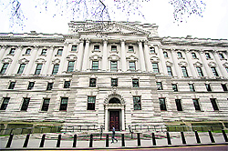 A pedestrian walks past the UK's Treasury building in central London. Britain suffered its first ever sovereign ratings downgrade from a major agency on Friday when Moody's stripped the country of its coveted top-notch triple-A rating, dealing a major blow to Finance Minister George Osborne