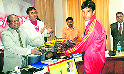 Chief Post Master General John Samuel presents shawl to a volunteer in Reasi on Saturday