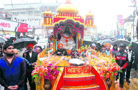 A shobha yatra being taken out to mark the birth anniversary of Guru Ravi Dass in Jalandhar on Saturday.