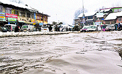 Vehicles wade through a waterlogged road in south Kashmir's Anantnag district on Saturday