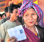A woman shows her voters ID slip at a polling station in the Harlibagan area of Meghalaya on Saturday. PTI