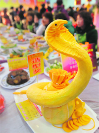 snake bite: A dish created in the shape of a snake is presented on a table during an annual local celebration for the Chinese New Year in Wuhan, Hubei province. In a celebration that has been held for some 13 years, community members cooked more than 8,000 dishes as new year gifts for their elderly and needy neighbours. Photo: Reuters