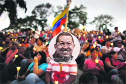 Praying for Chavez: People hold candles and pray for the health of Venezuelan President Hugo Chavez, who is undergoing cancer treatment, in Caracas on Friday. REUTERS