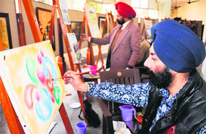 Artists during a workshop organised by the Indian Academy of Fine Arts in Amritsar on Sunday.