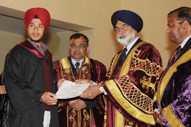 Flanked by Controller, Examinations, Punjabi University, Pawan Kumar Singla (left) and principal of Government Rajindra College, Vijay Goyal, Education Minister Sikander Singh Maluka, hands out the degree to a student during the convocation ceremony.