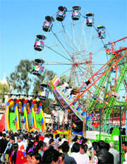 People enjoy in the Ferris Wheel at the fair organised on the birth anniversary of Guru Ravidass in Jalandhar on Sunday.
