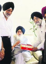 A file picture of Jaspal Pradhan offering sweets to Chief Minister Parkash Singh Badal after his election as Mayor. Cabinet Minister Surjit Singh Rakhra is also seen