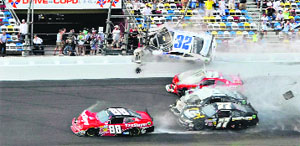 NASCAR driver Kyle Larson (32) and his Chevrolet end up in the fence during the final lap crash during the NASCAR Nationwide Series DRIVE4COPD 300 race at the Daytona International Speedway.