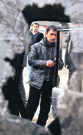 A security personnel is seen through the broken window of a suicide bombers vehicle in Kabul on Sunday.