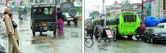 Traffic troubles: (Left) Cops stand as mute spectators while an auto-rickshaw flouts traffic rules by stopping in the middle of a road to pick passengers near the Hanuman Chowk in Bathinda; private and government buses stop at a point to pick passengers, despite a signage prohibiting such an act, near the Hanuman Chowk