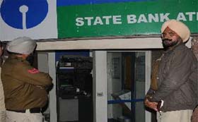 Policemen outside the State Bank of Patiala (SBoP) ATM on the Bathinda-Goniana Road after it was found open on Sunday