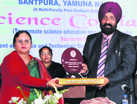 Principal Mrarinder Gandhi presents a memento to the chief guest during the Science Conclave at GNG College, Yamunanagar, recently.