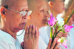 Cambodian nuns pray during the Meak Bochea Buddhist celebration in Kandal province on Monday.
