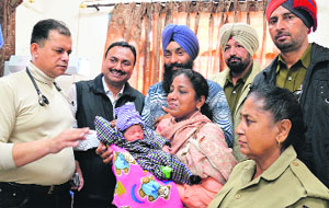 The abandoned baby being handed over to the members of SGB Childrens Home at the Civil Hospital in Ludhiana on Monday. 