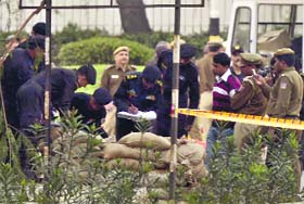 Experts inspect a bag found outside the Army hospital in New Delhi on Monday