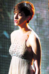 Anne Hathaway (R) dons a Prada halter-neck satin  gown