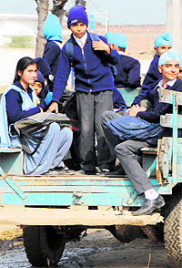 A vehicle ferries schoolchildren in a dangerous fashion in Amritsar on Tuesday