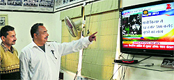 Employees of a government department watch the live telecast of the railway budget in Amritsar on Tuesday