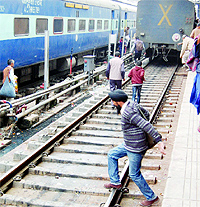 To save time, a passenger risks his life to board a train in Amritsar on Tuesday
