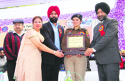 DSP Avneet Kaur Sidhu, a former Olympian, being presented a memento at the PTUGZS athletic meet on Tuesday. A Tribune photo
