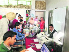 People await their turn to get their Aadhar cards prepared.
