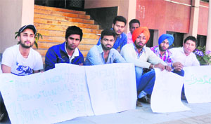 Students sit on a hunger strike outside the principals office at DAV College in Sector 10, Chandigarh, on Tuesday.
