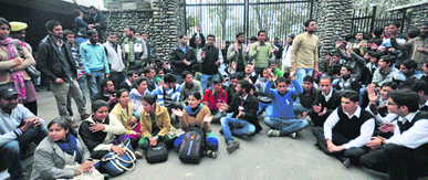 Scholars and students of Jammu University protest near the varsitys main gate