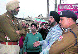Police officers at the site where the firing incident took place in Jalandhar on Tuesday
