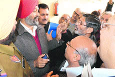Residents argue with Akali MLA Ranjit Singh Dhillon over the delay in the public hearing at the Zone A office of the MC in Ludhiana on Tuesday.