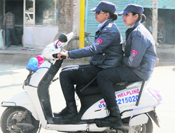 Two months after the Women Armed Special Protection Squad (WASPS) was introduced in Bathinda to keep an eye on offenders, two of its members flout traffic rules by riding a scooter without a helmet in the city. Tribune photo: Pawan Sharma