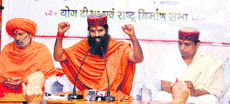 Ramdev and his aide Balkrishen at a rally in Solan on Wednesday.
