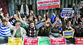 Kashmiri Migrant Relief Holders protest against the state government outside the exhibition ground in Jammu on Wednesday