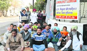 Members of the BSNL Casual and Contract Labour Union stage a dharna in Ludhiana on Wednesday