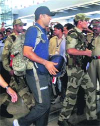 India skipper MS Dhoni being escorted out of Hyderabad airport on Wednesday