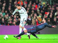 Gerarad Pique vies with Cristiano Ronaldo during the Spanish Cup semifinal at Barcelona on Tuesday
