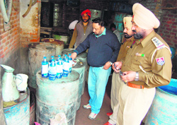 Police officials seal the samples of turpentine oil, seized from a factory, in Amritsar on Thursday. Photo: Sameer Sehgal
