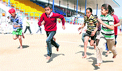 Children take part in the selection trial at the sports stadium in Bathinda