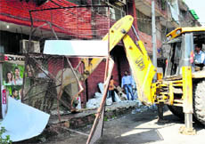 A demolition drive in progress at Sector 20 in Chandigarh on Thursday.