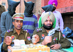 Police personnel display the stolen goods that were recovered from three members of a gang of thieves on the Jalandhar-Kapurthala road on Thursday. 